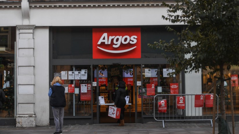 Business professionals in a meeting discussing economic trends, with charts and graphs displayed on a presentation screen.