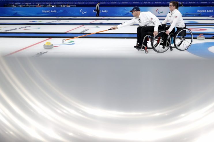 Breaking news event with reporters and cameras gathered at a press conference with a corporate backdrop and branding logos