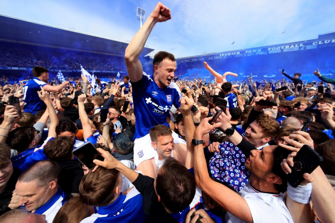 IPSWICH, ENGLAND - MAY 04: George Edmundson of Ipswich Town celebrates promotion to the Premier League with fans following the Sky Bet Championship match between Ipswich Town and Huddersfield Town at Portman Road on May 04, 2024 in Ipswich, England. (Photo by Stephen Pond/Getty Images)