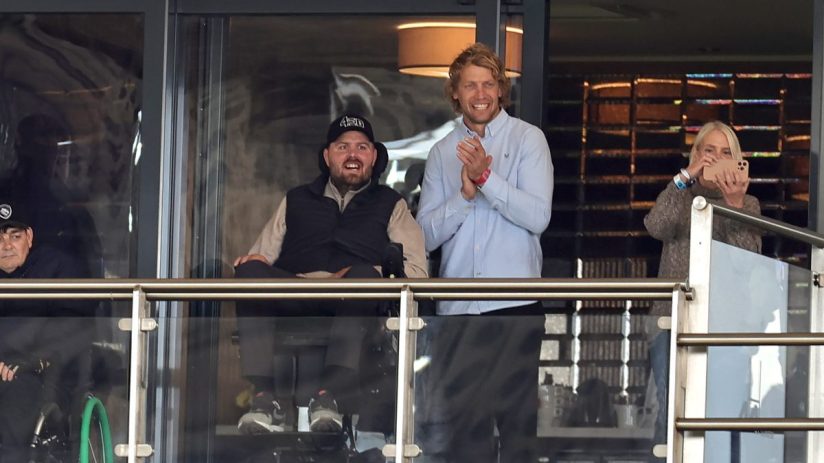 GettyImages 2179823642 showing a dynamic business meeting with professionals engaged in discussion around a conference table