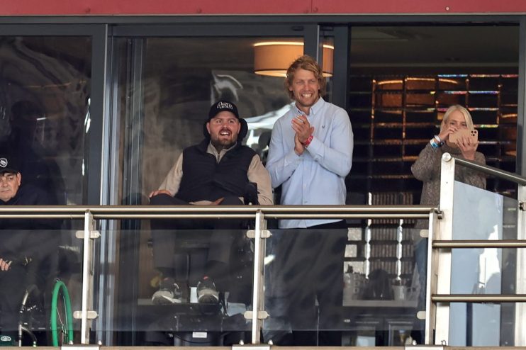 GettyImages 2179823642 showing a dynamic business meeting with professionals engaged in discussion around a conference table