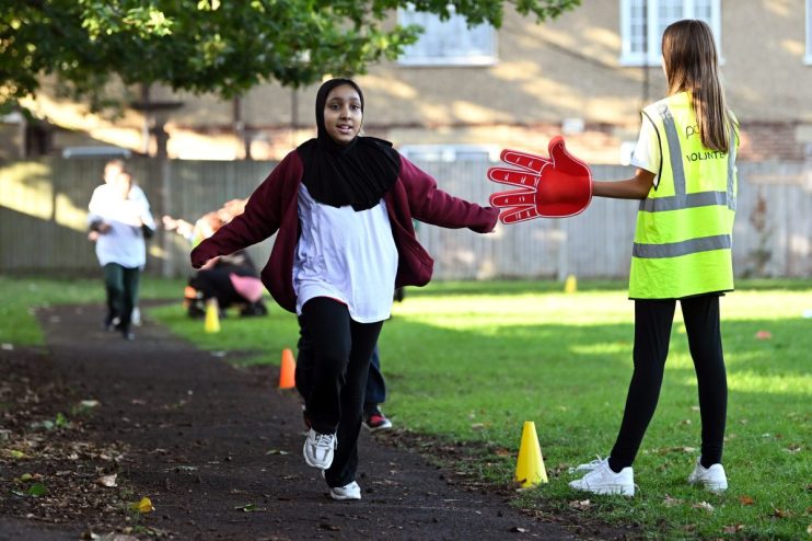 A diverse group of business professionals in a modern office discussing a project, showcasing teamwork and collaboration.