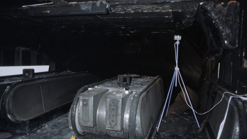 Breaking news update with dynamic newsroom setting, featuring journalists working at computers and a digital world map dis...