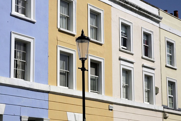 Luxurious mansions surrounded by manicured gardens in an upscale residential neighborhood, highlighting opulent housing tr...