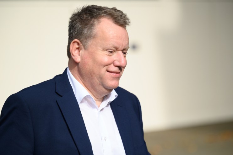 Lord David Frost addressing media on current political issues, wearing a suit and tie, with a serious expression.