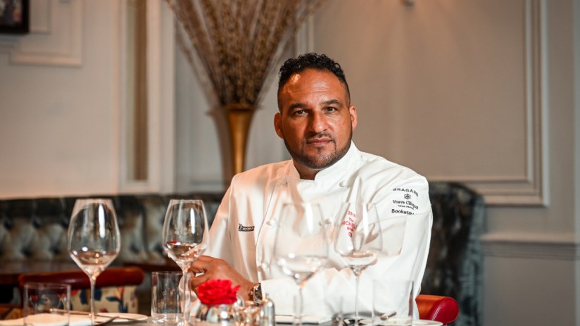 Renowned chef Michael Caines presenting his signature dish at a culinary event, showcasing innovative fine dining techniques.