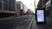 Oxford Street during Covid lockdown with empty sidewalks, closed shops, and minimal pedestrian presence in central London
