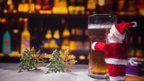 Festive pub interior adorned with Christmas decorations, sparkling lights, and patrons enjoying holiday cheer