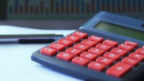 Calculator and financial documents on a desk, symbolizing business accounting and financial analysis processes