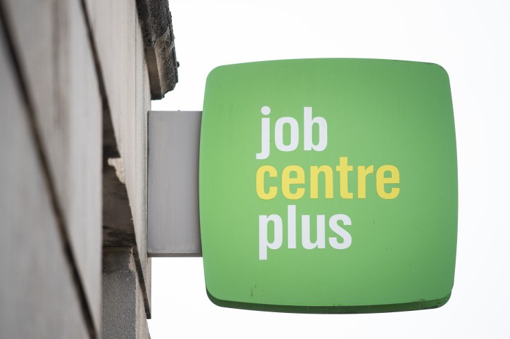 Job seekers entering a bustling job centre, engaging with career advisors and exploring employment opportunities.