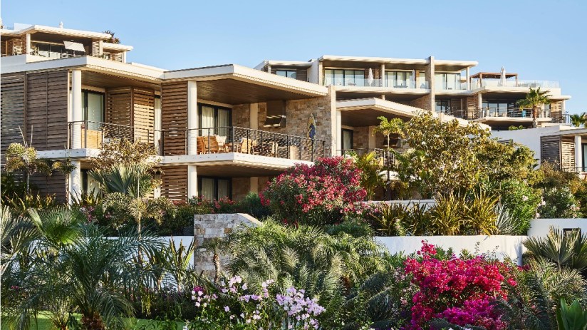 Scenic view of Los Cabos coastline with clear blue waters and rugged cliffs, highlighting popular tourist destination.