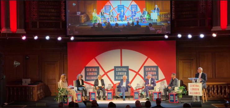 Panel discussion on growth opportunities featuring five industry experts in a business conference setting.