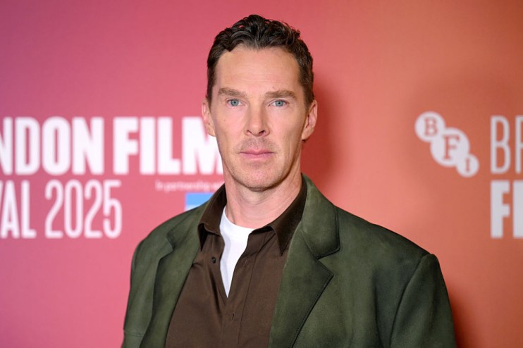 Benedict Cumberbatch attending a red carpet event, wearing a tailored suit and posing for photographers amidst a crowd.