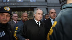 Bernie Madoff in a courtroom setting, wearing a suit, showcasing expressions related to financial fraud trial news.