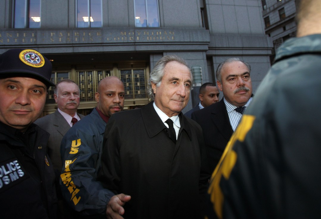 NEW YORK - JANUARY 5:  Bernard Madoff (C) walks out from Federal Court after a bail hearing in Manhattan January 5, 2009 in New York City. Madoff is accused of running a $50 billion Ponzi scheme through his investment company. Madoff is free on bail and hasn�t formally responded to the charges or entered a plea.  (Photo by Hiroko Masuike/Getty Images)