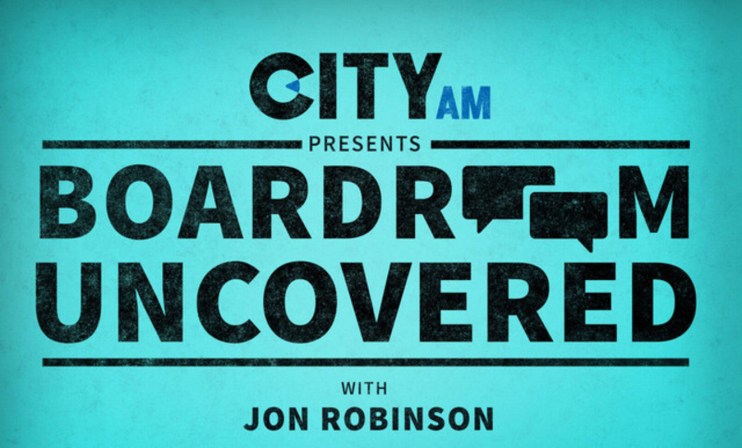 Corporate executives engaged in a strategic meeting around a modern boardroom table, discussing business growth strategies.