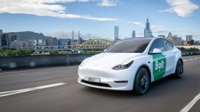 Electric Bolt car parked in urban setting, showcasing sleek design and eco-friendly transportation for modern city living.