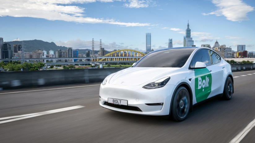 Electric Bolt car parked in urban setting, showcasing sleek design and eco-friendly transportation for modern city living.