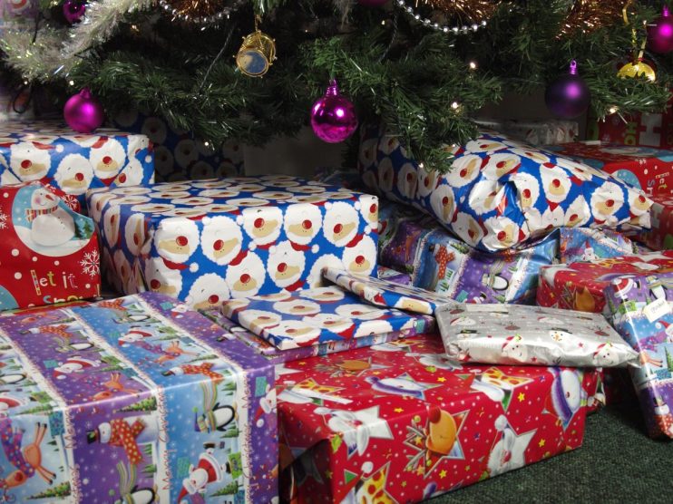 Festive holiday scene with beautifully wrapped Christmas gifts under a decorated tree, perfect for seasonal celebrations.