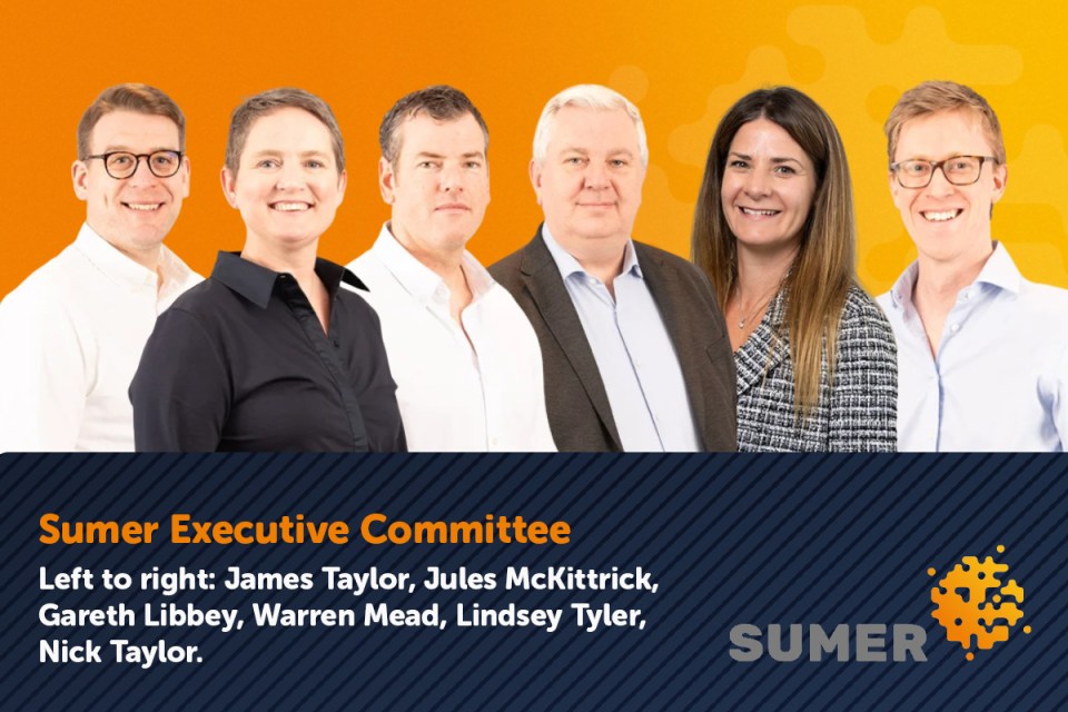 Group shot of Correct Sumer team with a company legend, highlighting a diverse team in a business setting