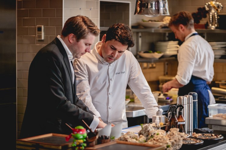 Justin DeSouza at DaTerra showcasing sustainable practices in a vibrant restaurant setting