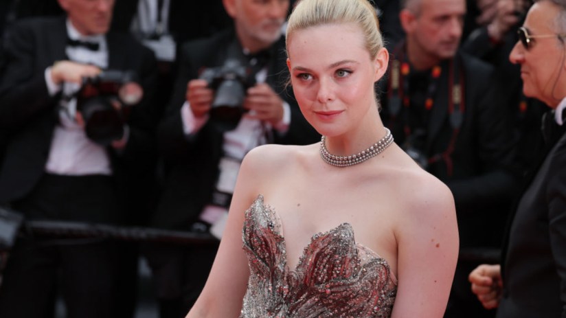 Elle Fanning attending a public event, dressed elegantly, showcasing her iconic style and poised demeanor amidst a crowd.