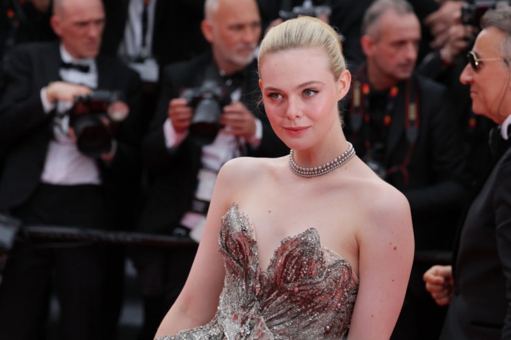 Elle Fanning attending a public event, dressed elegantly, showcasing her iconic style and poised demeanor amidst a crowd.