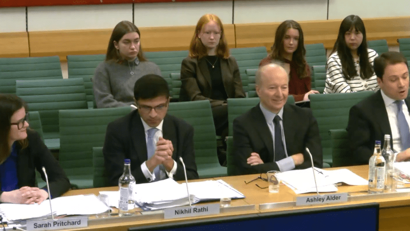 FCA committee discusses financial regulation reforms, chaired by Alder, in a formal meeting setting with documents and lap...