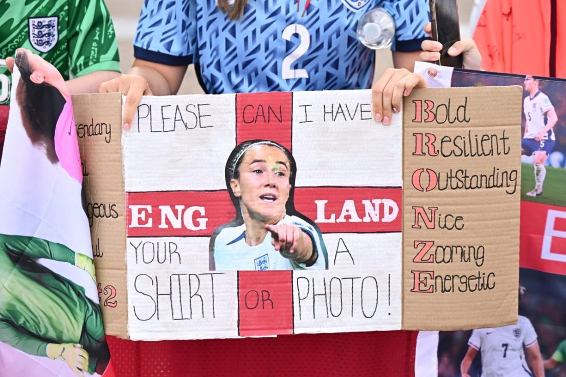 SOUTHEND, ENGLAND - JULY 28: A fan holds a sign dedicated to Lucy Bronze as spectators wait for the England Women's Squad to arrive back at Southend Airport on July 28, 2025 in Southend, England. England defeated Spain in the UEFA Women's EURO 2025 Final to retain the trophy on 27 July. (Photo by Leon Neal/Getty Images)