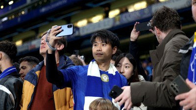 GettyImages 2245711103 featuring a business meeting with diverse professionals discussing corporate strategies around a co...