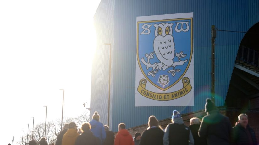 GettyImages 2248044945 captures a professional business meeting with diverse executives discussing strategies around a con...