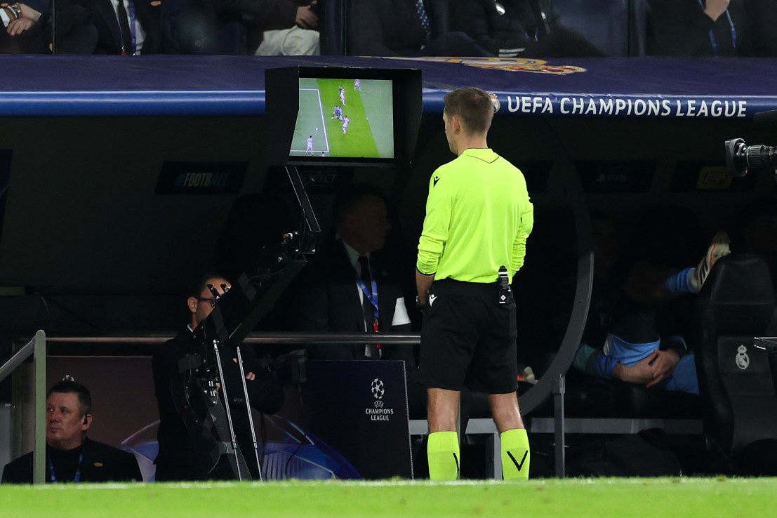 MADRID, SPAIN - DECEMBER 10: Referee, Clement Turpin checks the VAR screen before awarding a penalty to Manchester City during the UEFA Champions League 2025/26 League Phase MD6 match between Real Madrid C.F. and Manchester City at Estadio Santiago Bernabeu on December 10, 2025 in Madrid, Spain. (Photo by Florencia Tan Jun/Getty Images)