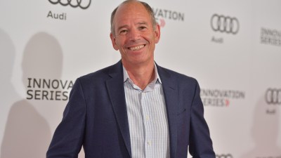 Business professionals discussing strategy in a modern office setting, with a focus on teamwork and collaboration.