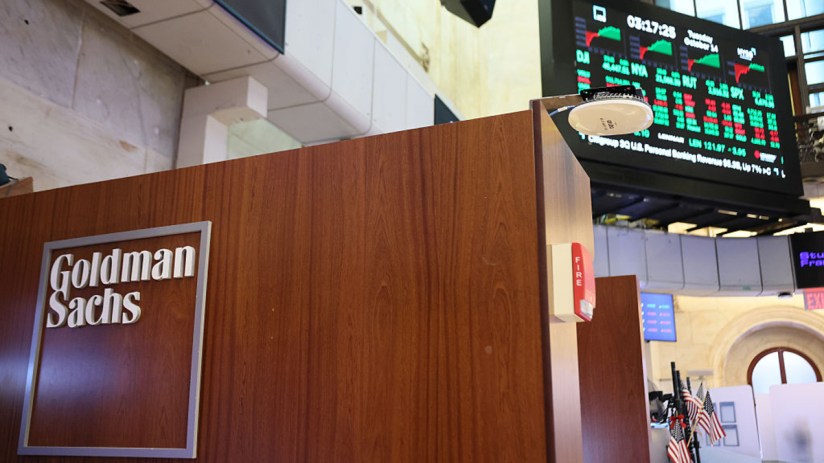 Goldman Sachs private credit team discussing financial strategies in a modern office setting, focusing on investment oppor...