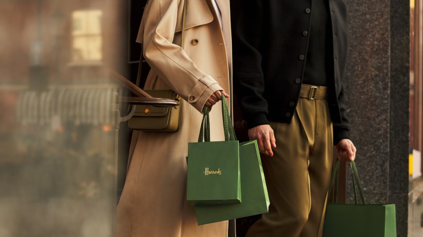 Shoppers browsing modern winter apparel in a high-end retail store, highlighting current fashion trends and consumer engag...
