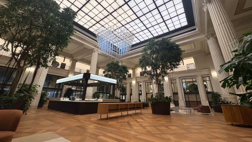 Breaking news event coverage with reporters interviewing key figures in a bustling press conference setting