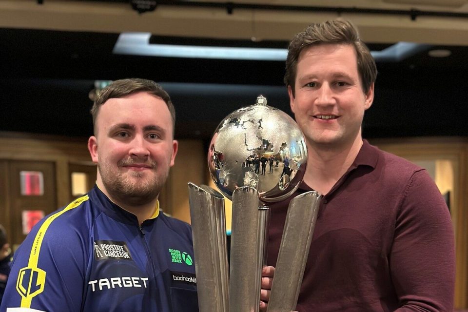 James and Luke discussing project details in an office setting, highlighting teamwork and collaboration in a business envi...