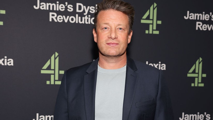 Jamie Oliver speaking at a culinary event, showcasing healthy recipes and sustainable cooking practices.