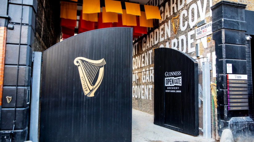 Open gate on December 1st at event, showcasing festive decorations and welcoming crowd at business venue.