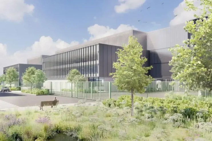 Pinewood Studios construction site showcasing expansion progress with cranes and building materials in a bustling work env...