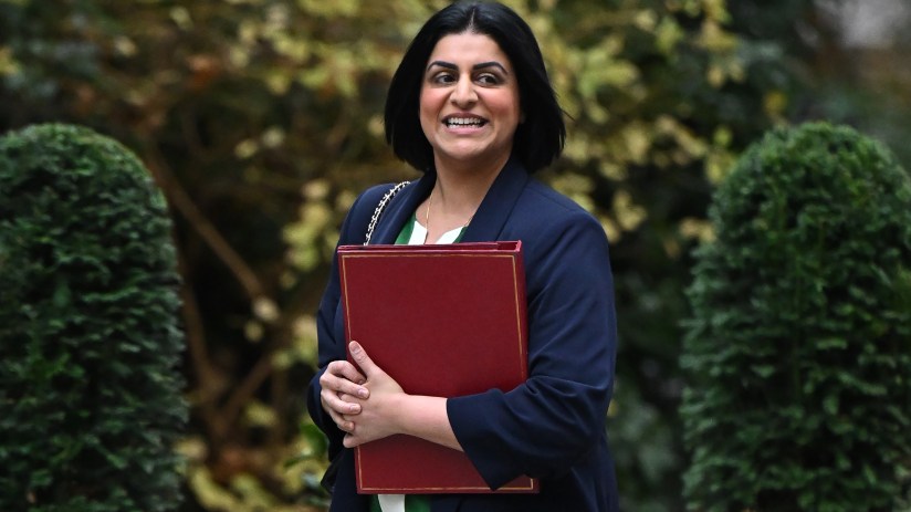 Shabana Mahmood smiling during a public address, wearing a professional outfit, representing leadership in a political con...