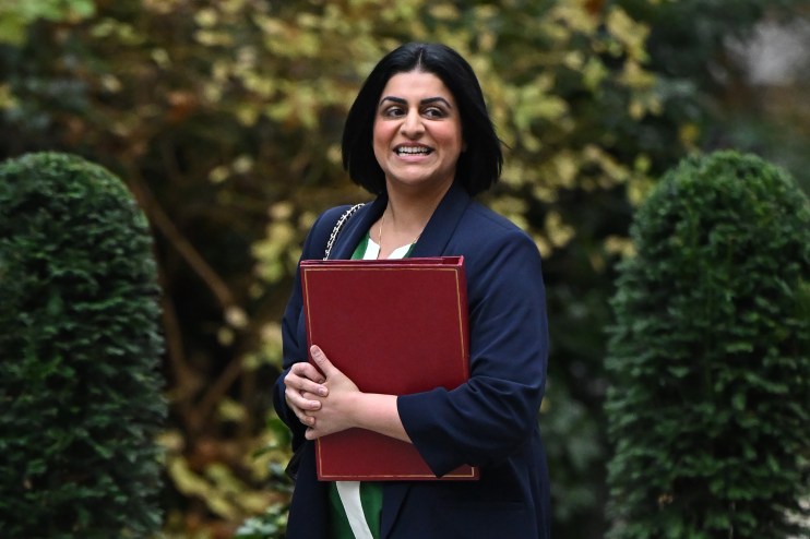 Shabana Mahmood smiling during a public address, wearing a professional outfit, representing leadership in a political con...