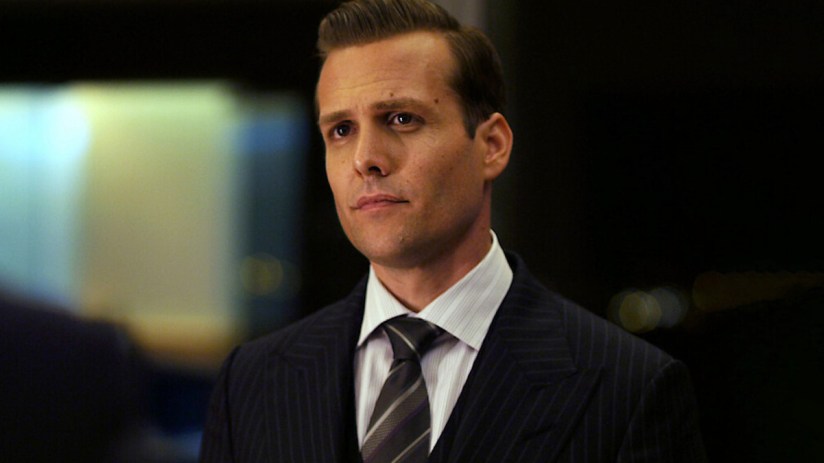 Business professionals in formal suits engaged in a meeting, discussing strategies in a modern office setting.