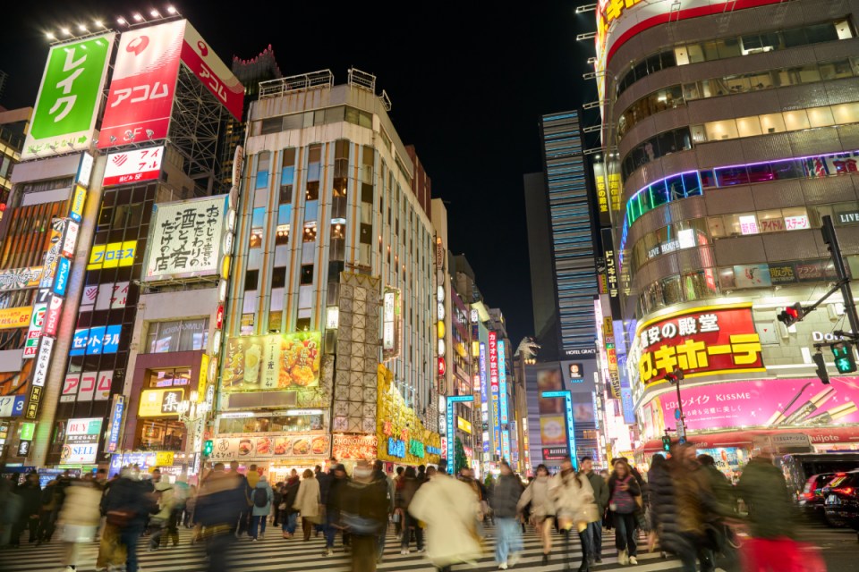 Tokyo cityscape illuminated by vibrant neon lights, showcasing bustling streets and modern architecture in a lively nightt...