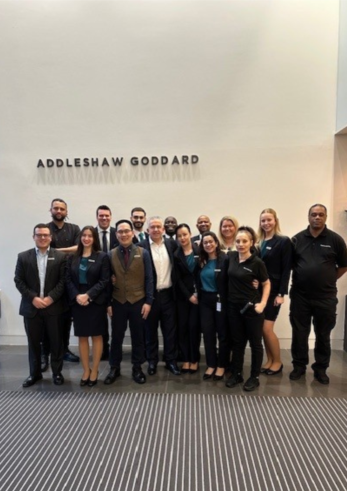 Business meeting with diverse team discussing strategy around a conference table, with charts and laptops visible