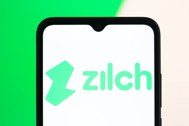 Zilch logo on a modern office building facade reflecting a clear blue sky, symbolizing innovation and corporate presence.