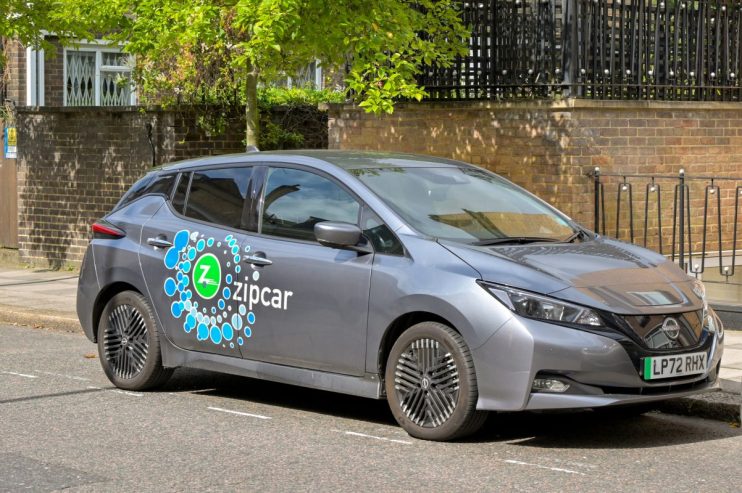 Zipcar vehicle parked in urban setting, highlighting convenient car-sharing service for city commuters and eco-friendly tr...