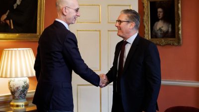 General news article image with diverse group of professionals discussing a project in a modern office setting.