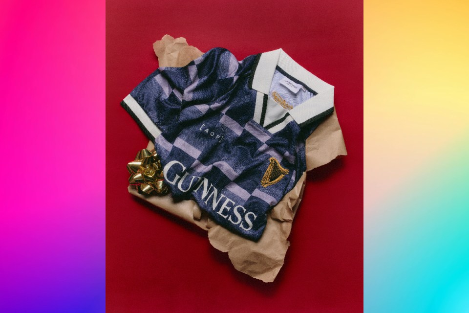 Christmas gifts 2025: Person wearing a Guinness-branded shirt, showcasing the iconic logo, possibly at an event or gathering related to the brand