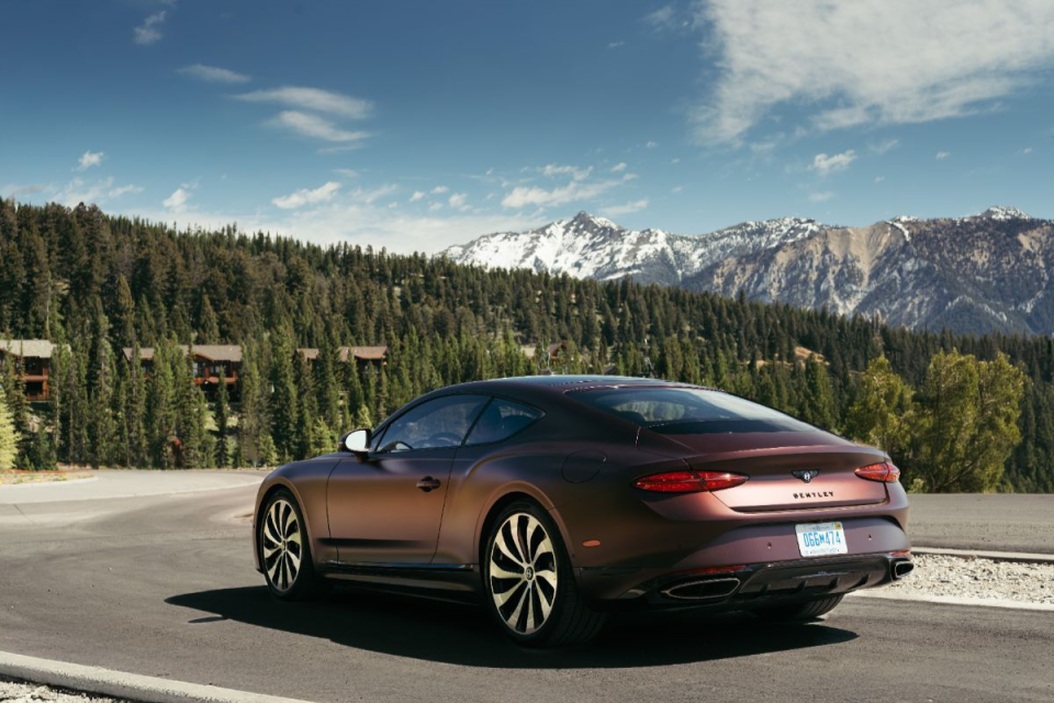 Breaking news event with reporters gathered, microphones in foreground, and speaker at podium under bright lights